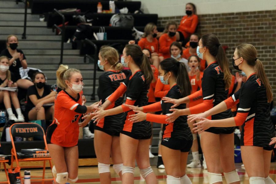 The girls Varsity Volleyball team cheers on their teammate Senior Bella Henson before the game begins. The Tigers later won all three sets against Kearsley.