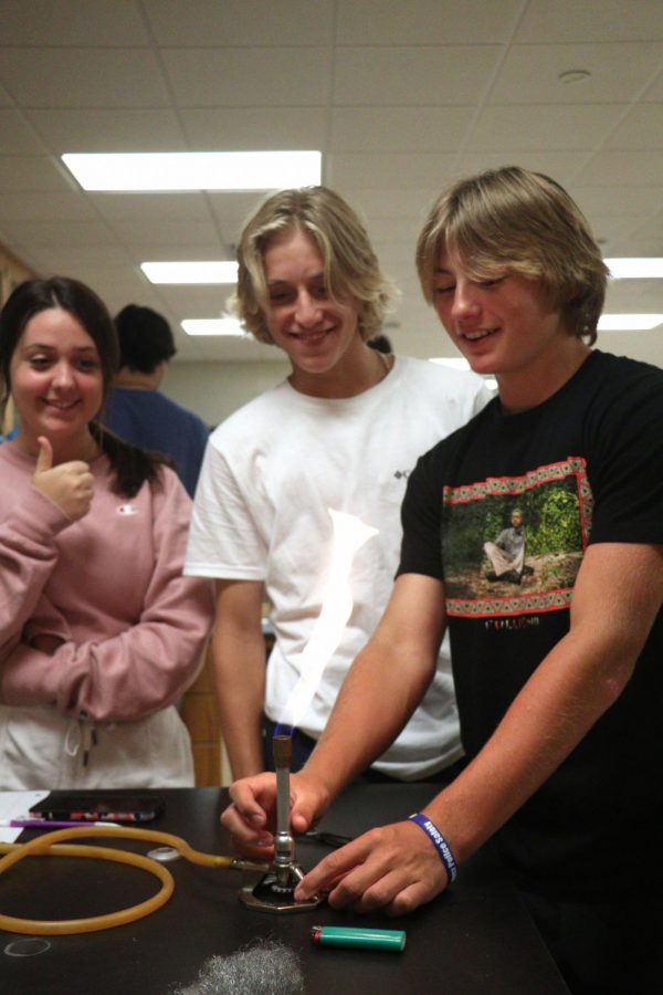 Juniors Gena Duffy, Caden Crandall, and Adam Barcome complete a lab in Chuck Millers chemistry class. On Aug. 31, these students learned about physical and chemical mass changes.
