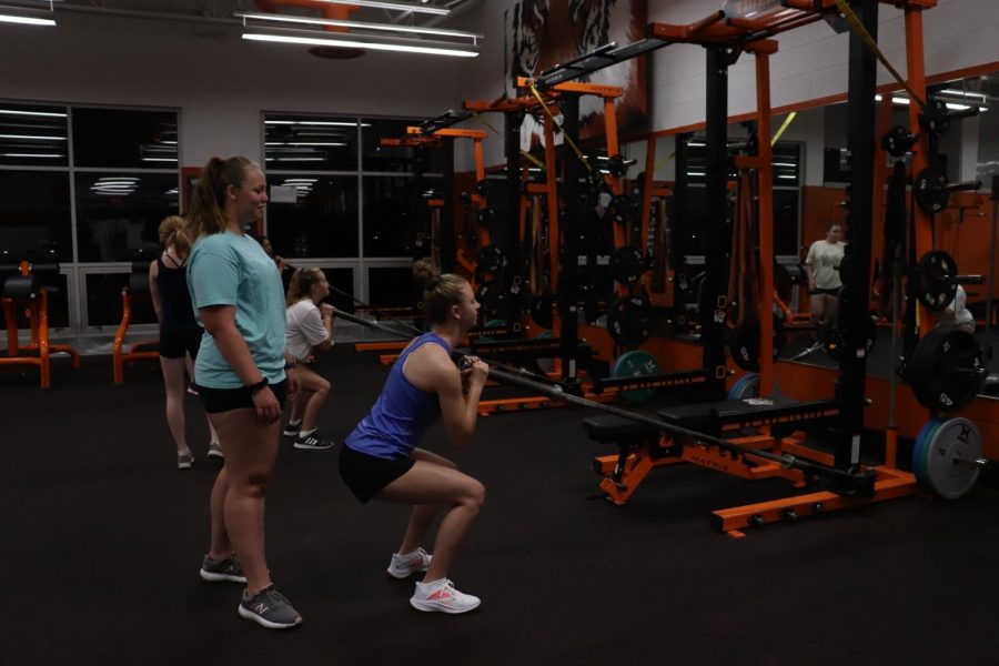 Freshman Kylee Brandon is lifting weights with her teammates. On Sept. 2, the Fenton swim & dive team started their morning off at 5:50 a.m. in the weight room.