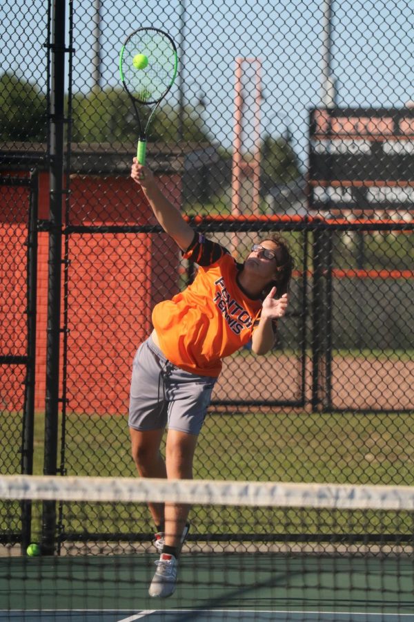 Junior Tate Webb serves to his opponent. On Sep. 2, the Fenton tennis team faced Holly winning 5-3.