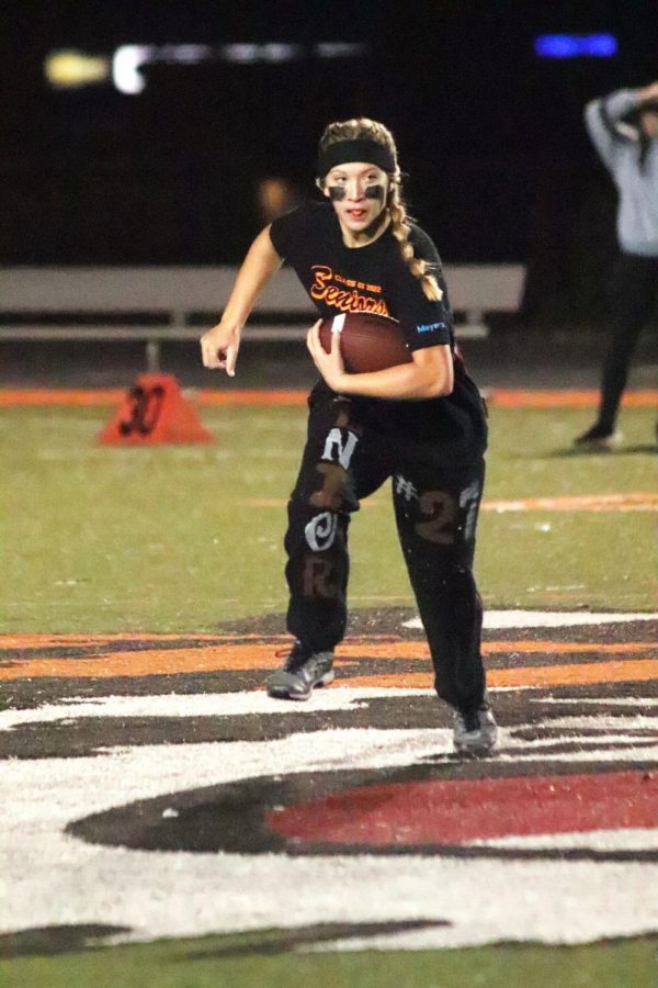 Senior Jessica Dunkel runs to make a play against the juniors. On Oct. 18, the seniors and juniors played against each other in a powderpuff game to kick off homecoming week.