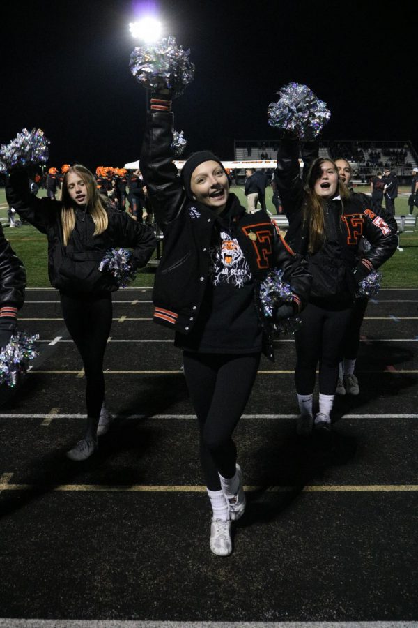 Senior Kailey Bombe Cheers for the Fenton Tigers on Oct.22. The tigers played against Walled Lake Northern for their homecoming game. the game was close until the final second, where the Tigers lost. 