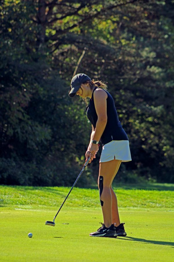 Freshman Sophia Rossi puts in her match. On Sept. 29, the Jv Girls Golf team competed in a golf tournament at Hartland Glen.