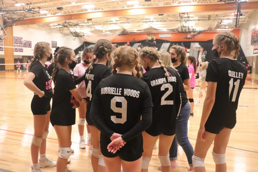 The freshman volleyball team in a huddle before their game against flushing on Oct. 7. The coach is giving them a pep talk to get them ready to get a big win. 