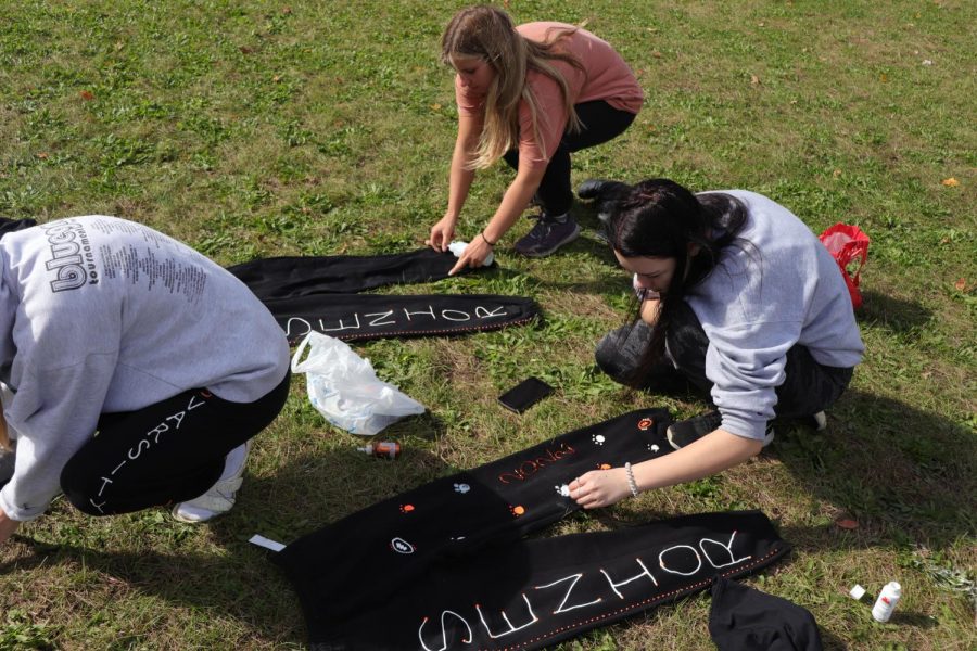 Seniors Katie Premo and Olivia Resa decorate their powderpuff pants. On Oct. 18, the girls had their game against the juniors who won 21-20. 