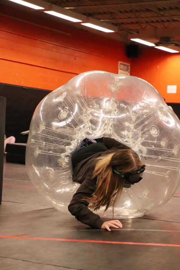 Senior Elly Beaven fights to get up and finish her race. On Oct. 13, Matt Sullivans Forensics classes met in the wrestling room for drunk goggles bubble soccer competitions.