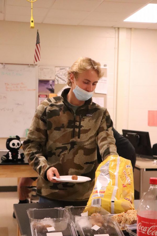 During Student Resource Time, senior Chase Coleman grabs snacks at the Halloween party. On Oct. 28 , Student Resource Time (SRT) classes celebrated the holiday by having small parties.
