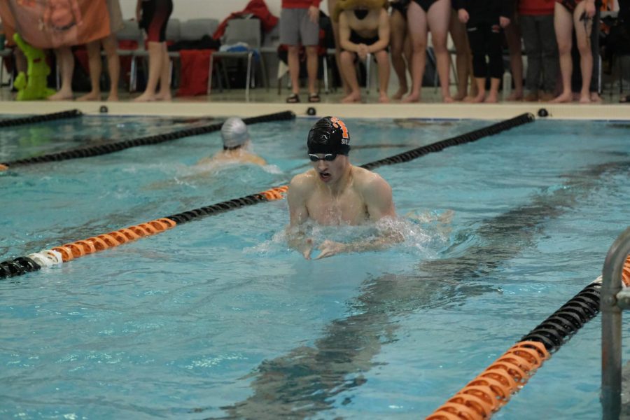 Swimming the breaststroke in the 400 yard medley relay, senior Kaz Sieja makes his way down the lane. On Dec. 3, the Fenton boys swim and dive team took on the Tiger Relays the Fenton Tigers placed eighth.