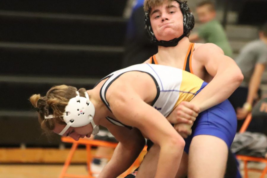 Picking up his opponent, junior Kyle Dunfield goes  for a pin.  On Dec. 15, Dunfield lost his match against Imlay City.  