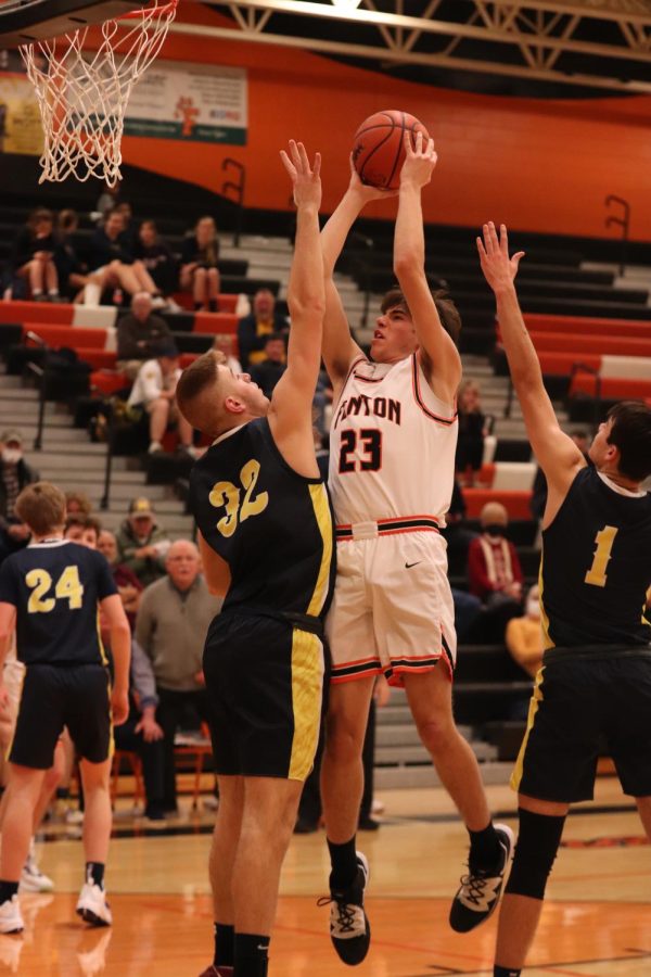 Going up to the basket, junior Justin Banura attempts to score. On Jan. 4, the Fenton Tigers defeated the Goodrich Martians 59-49. 