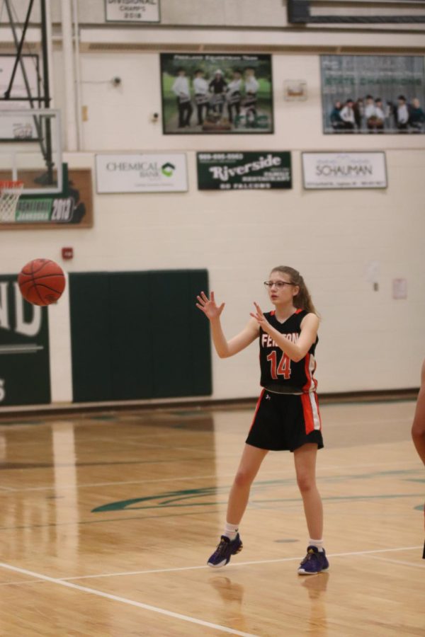 Freshman Addison Browne catches the basketball. On Jan. 18, the freshmen girls basketball team played Freeland High and lost 28-34. 