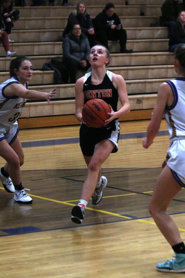 Going+up+for+a+layup%2C+junior+Grace+MacCaughan+attempts+to+score.+The+girls+varsity+basketball+team+played+against+Kearsley+on+Feb.+11%2C+and+won+54-26.
