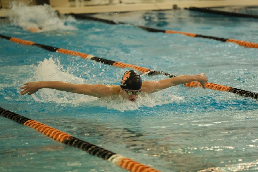 On Feb. 8, junior Max Haney swims fly against Swartz Creek. Haney swam the 100 fly in 54.09 and placed first. 