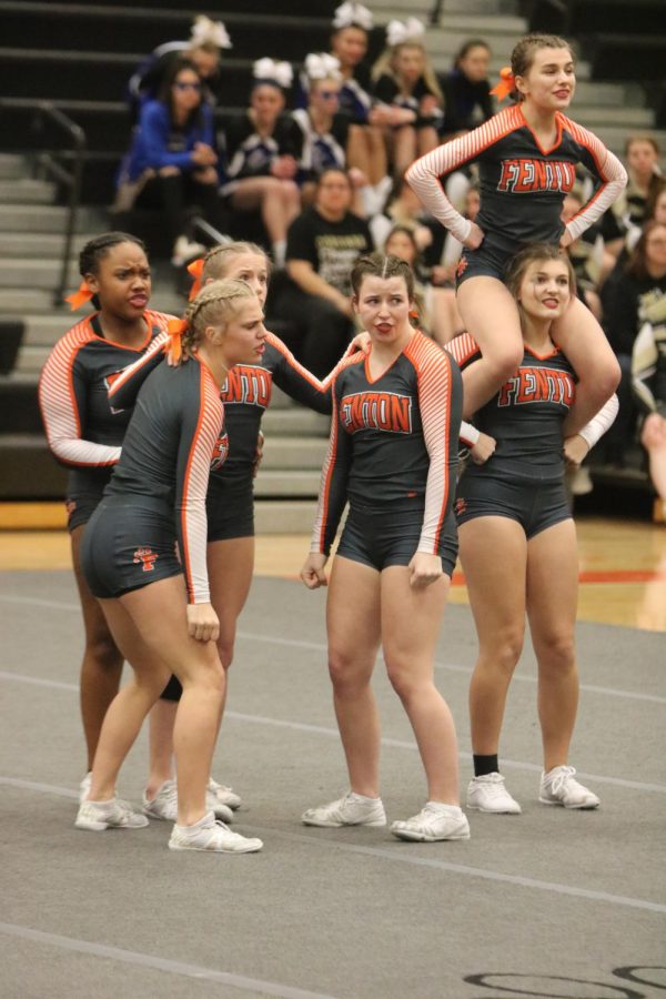 Senior Brooklyn Bond prepares to stunt with her teammates during round 3. On Feb. 11, FHS held the Flint Metro League competition where the varsity cheer team was named Flint Metro League champions for the second year in a row. 
