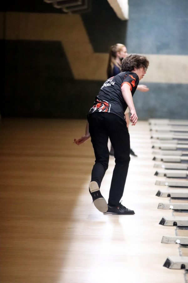 Senior Richard Rockman waits to see how his bowling ball will strike the pins. The Fenton Bowling team bowled against Corunna at Colonial Lanes on Jan 29.