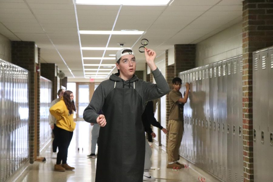 Throwing his bird, sophomore Brock Litogat tests its flight ability. On Feb. 16, FHS teacher Heather Thomass biology classes learned about genetic traits. 