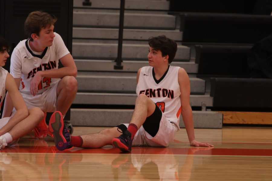 Sitting on the sidelines, freshman Jake Huntoon waits to be put into the game. The Fenton High freshman boys basketball team went up against Flushing HS on Feb. 24 and won 55-39. 