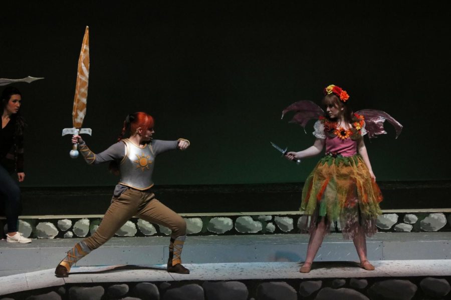 Fighting on the stage, senior Sky Hodgkin and junior Ella Beck swing at each other. On March 18, the IB theater students put on the play She Kills Monsters.  