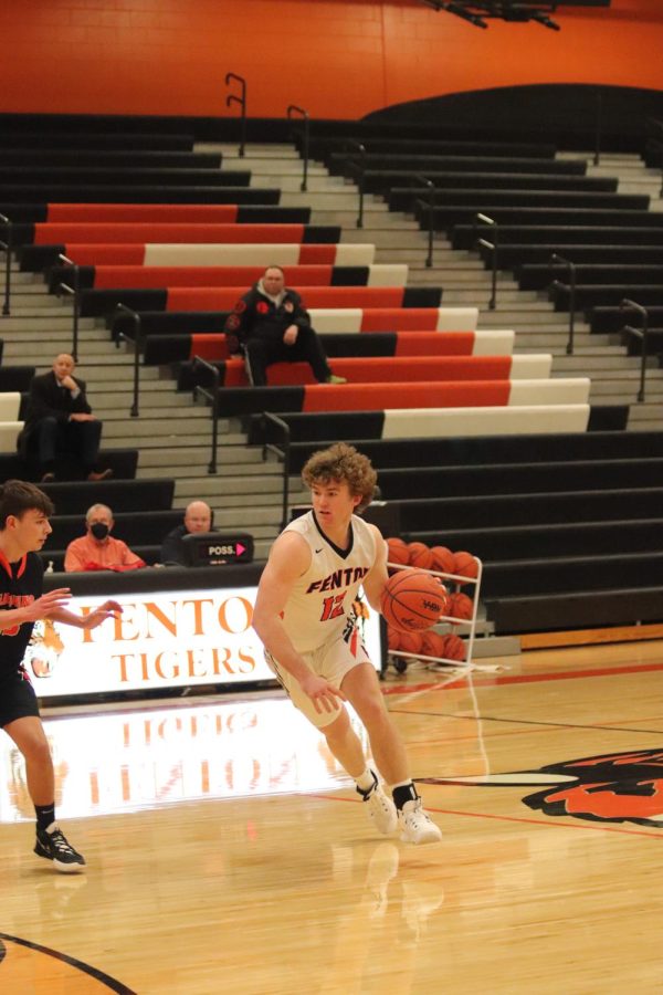 With the ball in his hand, sophomore Spencer Luck drives to the left after seeing an opening. On Feb. 24, the JV basketball team played against Flushing High and won 68-57.