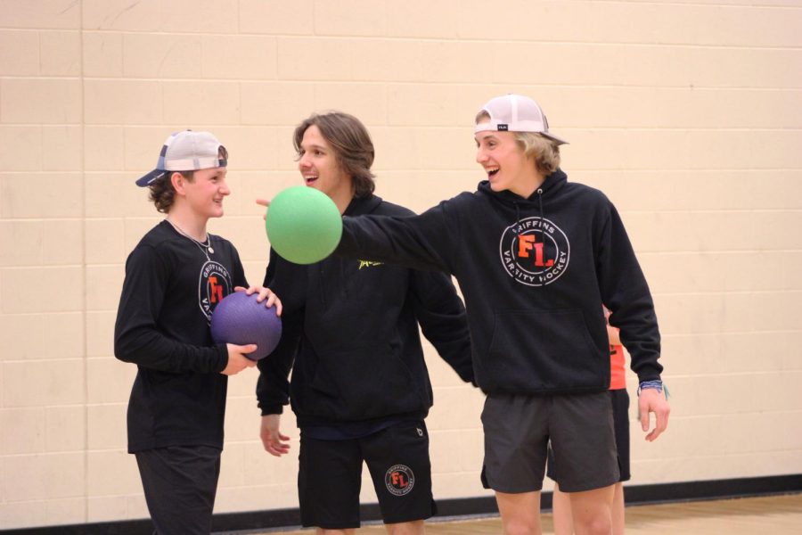 Juniors Jace Dumeah, Dylan Holloway, and Caden Crandall laugh together in a game of dodgeball. On March 12, the Griffins hosted a hockey lock-in for elementry kids to come to FHS and play games with the hockey players. 