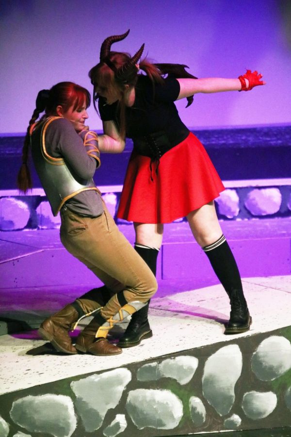 Junior Ella Beck yells at senior Sky Hodgkin on stage. On March 18, the Fenton IB theater class practiced their play in front of other students.