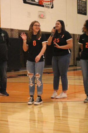 Varsity girls soccer player, senior Jilian Roberts waves to the crowd as she is introduced by team captain Macy Melero. On March 22, FHS held a ceremony honoring all athletes taking part in spring sports. 