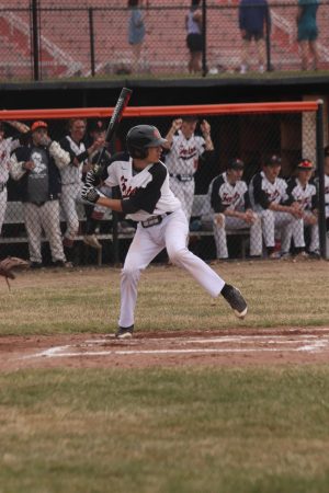 Watching the pitch, senior Quinn Hartley gets ready to hit. On April 11, the Tigers defeated the Swartz Creek Dragons with a score of 10-0. 