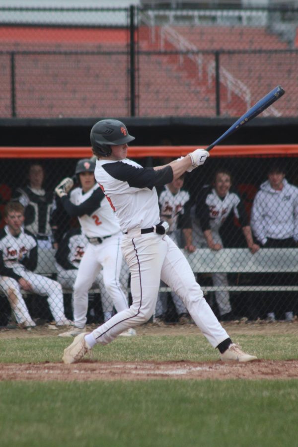 Eyeing the ball, sophomore Spencer Luck swings his bat. On April 20, the FHS boys varsity baseball team went up against Holly High at Fenton High School and won both their games 9-0 and 13-1. 