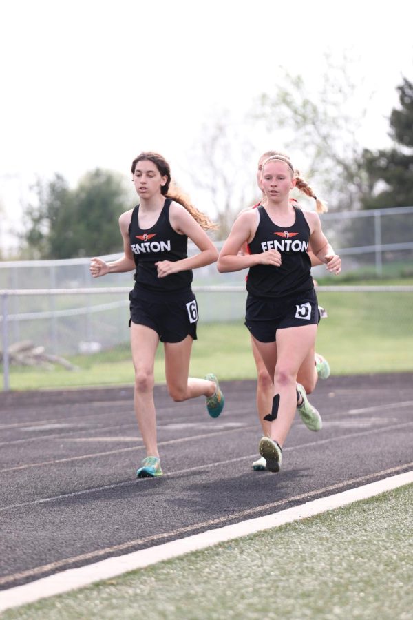 Running together, senior Emily Grob and sophomore Nina Frost run the 2 mile race. On May 11, the Fenton girls track and field team ran at the league meet hosted by Goodrich and became co-champions with Linden. 
