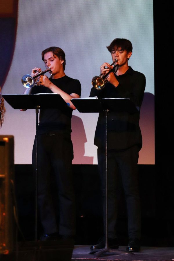 Playing the trumpets, sophomores Daniel Martens and Jackson Schmaltz perform on stage. The Fenton High bands had their last concert on May 12. 