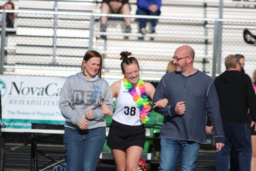 Walking down field with her parents, senior Jordyn Bliss on senior night for Fenton-Linden Heat lacrosse. On May 4, Fenton Athletics puts together senior night to honor class of 2022. 