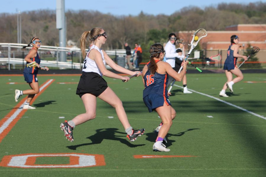 Senior Alexis Freeman attempts to block her opponent from scoring. On March 4, FHS girls varsity lacrosse competed against Powers and won the game 16-5.