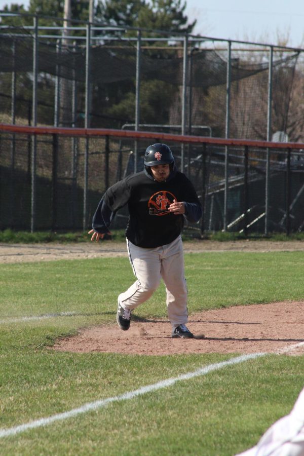 Taking off, team manager junior Micah Martinez runs the bases. On April 28, the Tigers defeated the Kearsley Hornets with a score of 14-1. 
