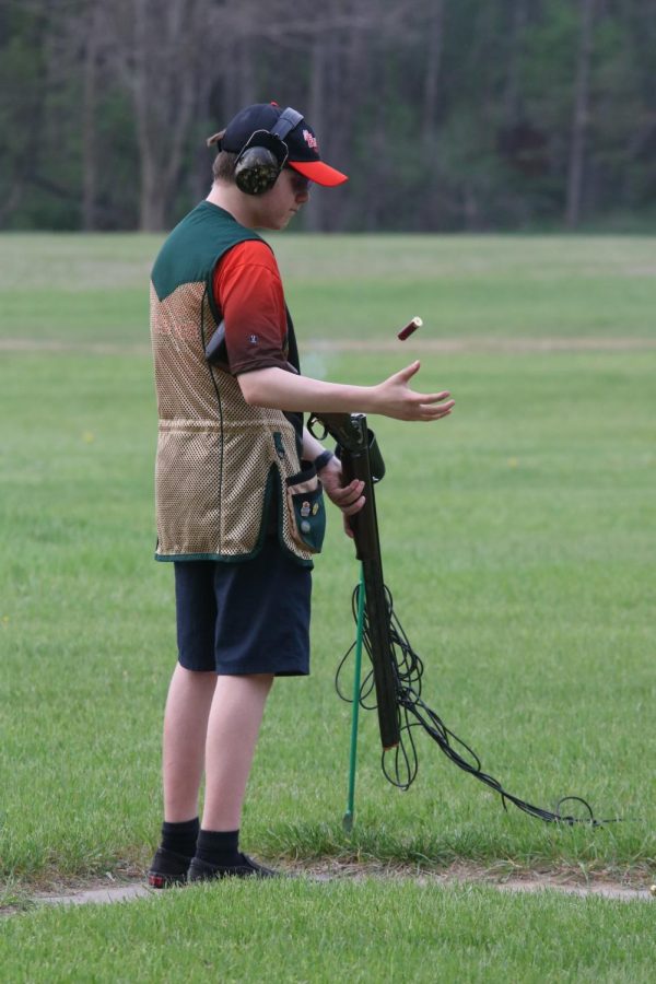 Sophomore Ryan Czop pops his casing out to reload. On May 11, the FHS trap team practiced shooting clay pigeons for their next competition.