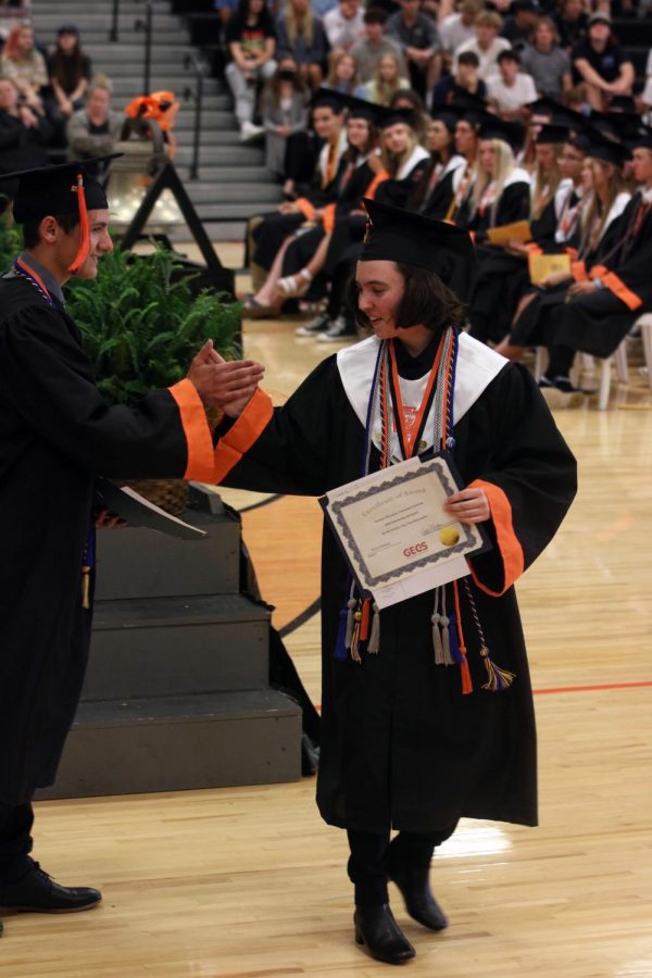 Seniors Fiona Dunlop and Gavin Thomas high-five each other. On May 26 the seniors did their Awards assembly before they graduated later in the day.