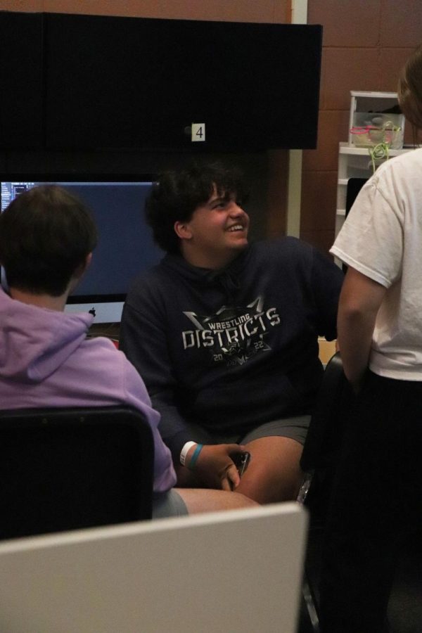 Talking with his classmates, sophomore Carson Krzeszak laughs about old videos that they made earlier in the school year. All the Video Production 1 classes worked on making a demo reel showcasing all the videos they have made within the 2021-2022 school year on April 29. 