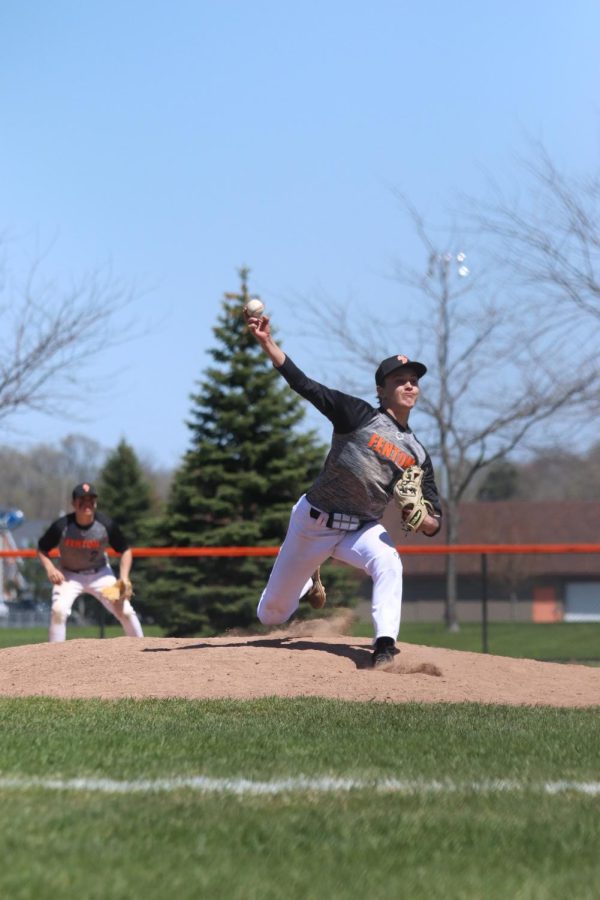 Striding out, junior Zachary Brown pitches the ball. On May 7, the Tigers hosted the annual Woodbat Tournament, beating Lake Fenton 8-2 and Powers Catholic 3-1. 