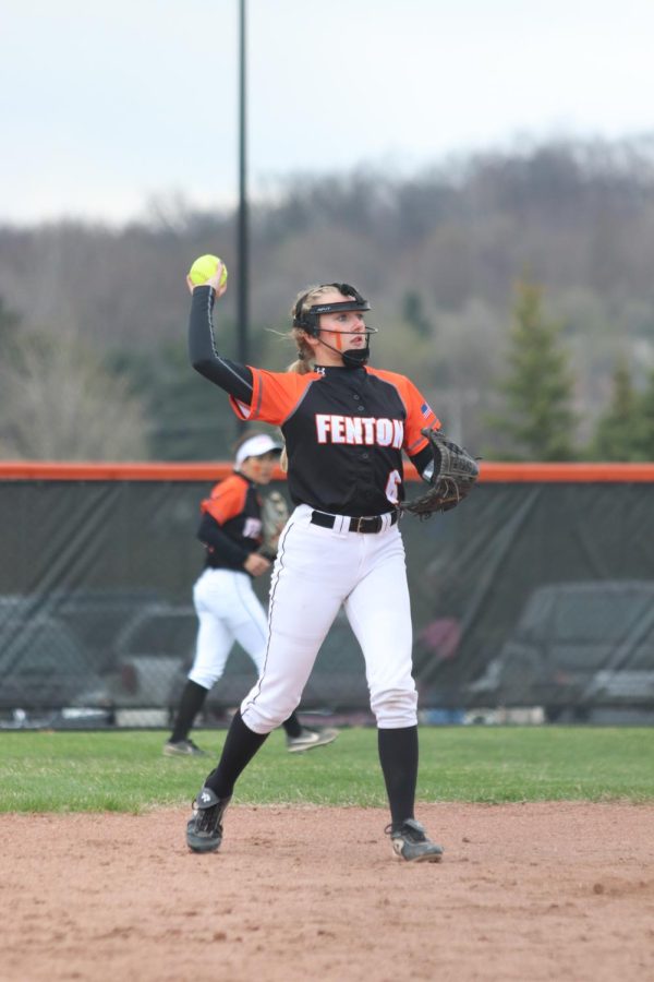 Throwing the ball, junior Grace Macaughan passes the ball back to her teammate on the FHS varsity softball field. The FHS girls varsity softball team played against Linden on May 2 and lost 4-9. 
