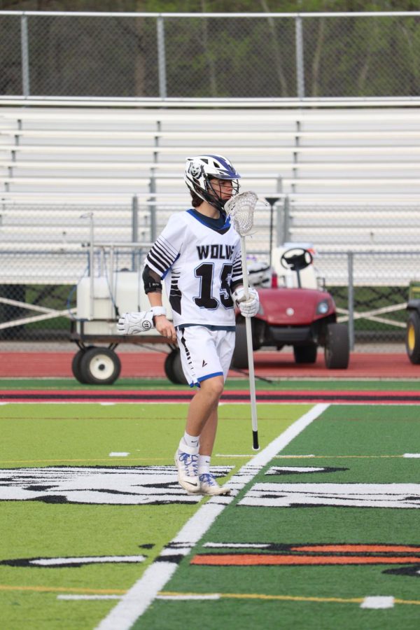 Making his way onto the field, sophomore Grant Hayden prepares to start the game. The Linden/Fenton Wolves varsity team went up against Swartz Creek on May 10 and won 18-5.  