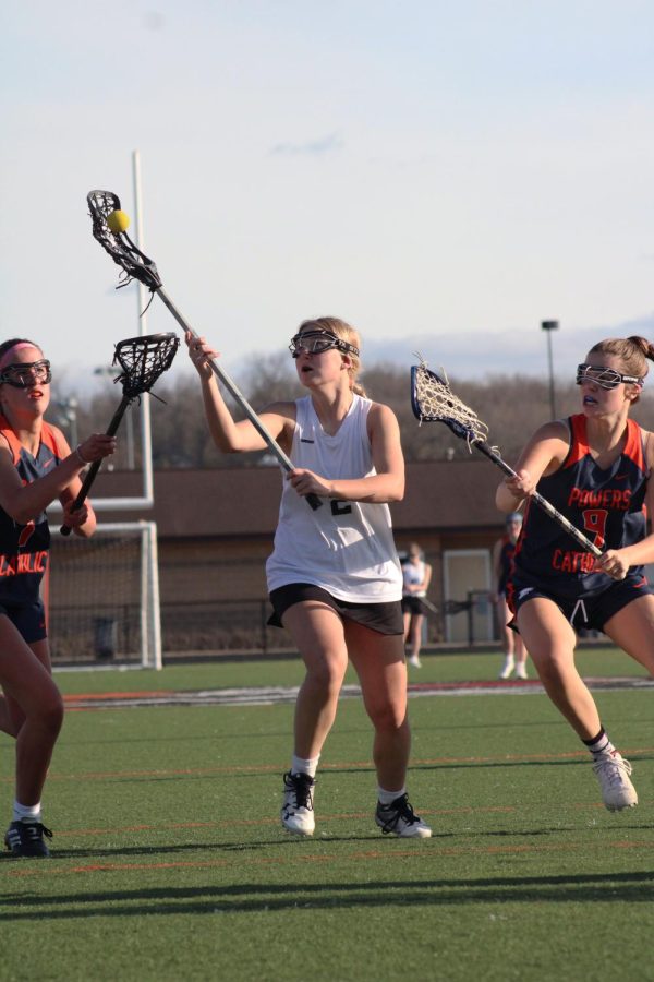 Shooting the ball, sophomore Shea Temrowski attempts to make a goal. On May 5, girls varsity lacrosse played Powers and won 16-6.