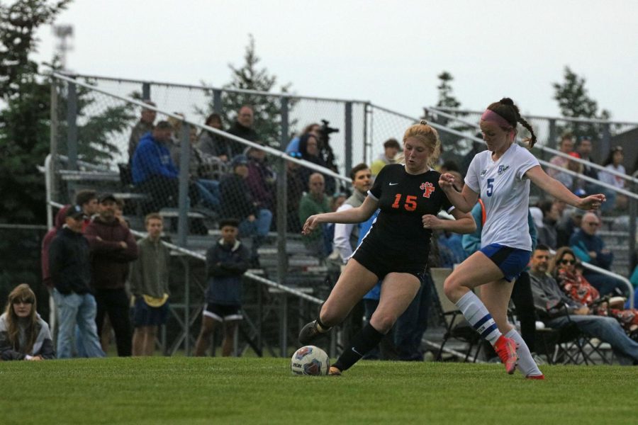 Preparing to kick the ball, senior Alexandria Browne battles with her opponent. On May 26, the girls varsity soccer team played Brandon in the first round of districts; winning 2-0. 