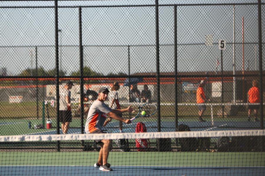 Backhanding his way to a win, senior Remy Book defeats his Clio opponent. On Sept. 8, the Fenton boys varsity tennis team took on the Clio Mustangs and lost 2-6.