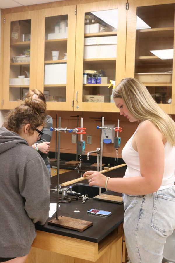 Taking notes, Freshman Aleah Charbonneau and Emma Davis learn how to balnces out forces. On Sep. 13 Kasaks 6th hour studies equilibrium. 