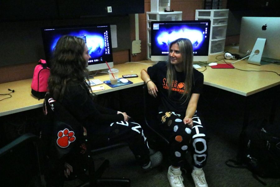 Talking to one another, seniors Paige Javor and Alexa Szpak discuss the powderpuff game. On Sep. 26, the senior girls will take on the junior girls in a game of flag football. 