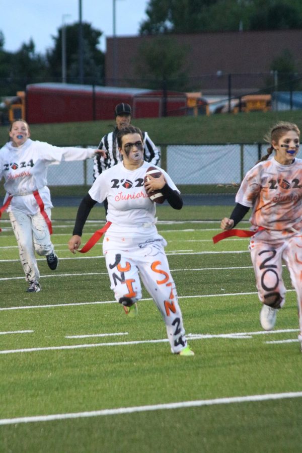Executing the play, junior Sara Kanaski runs tha ball down the field. On Sept. 26 to celebrate homecoming week, the juniors went up against the seniors in the annual FHS powderpuff game, and the seniors came out victorius with a score of 41-14. 