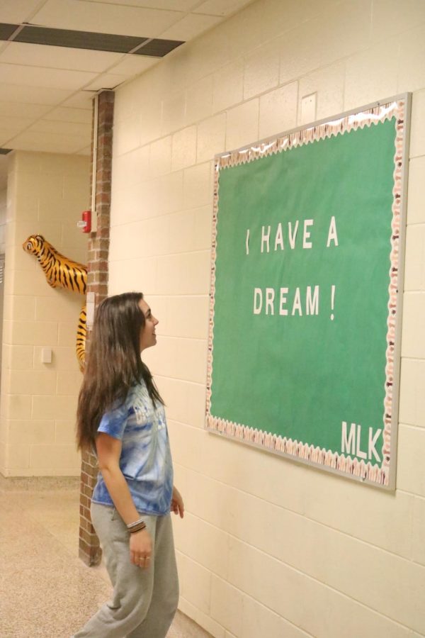 Looking, senior Lauren Caldwell reads the I Have A Dream poster. Caldwell participated in tye dye day on Sep. 27. 