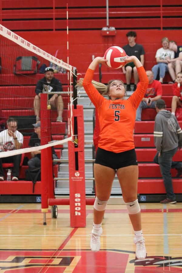 While jumping, junior Allison Mowery sets the ball. On Sept. 12, Fentons Varsity volleyball team played Swartz Creek; winning 3-0.