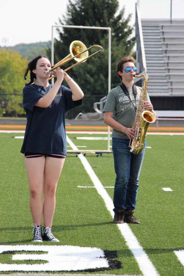 Playing their instruments in harmony, sophomore Reyna Fox and freshman Dominic Maini practiced with the Fenton Marching Band. On Sept 17, they prepared for the football halftime performances and the homecoming parade.  