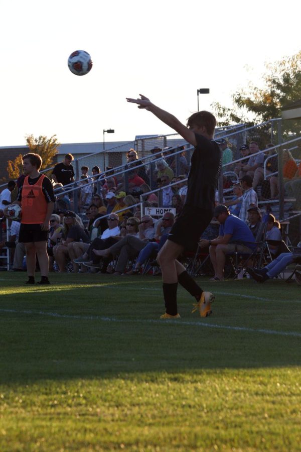 Throwing the ball in bounds, Senior Benjamin Grob makes an overhead pass to his teammates. On Sept. 8, the varsity soccer team tied 1-1 with Grand Blanc. 