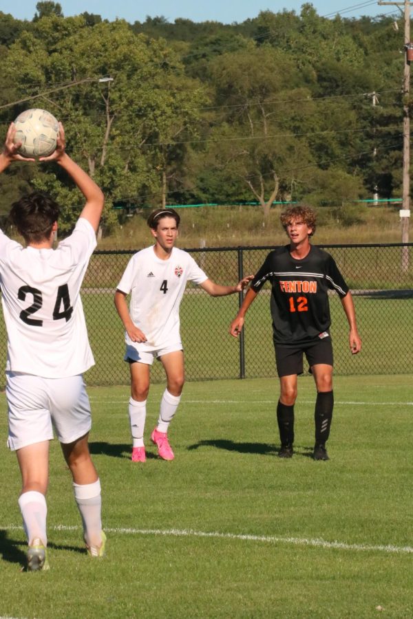 As the ball is thrown in bounds, sophomore Luke Rittenger keeps an eye on the ball. On Sep. 8, the JV soccer team fell to Grand Blanc with a score of 1-4. 